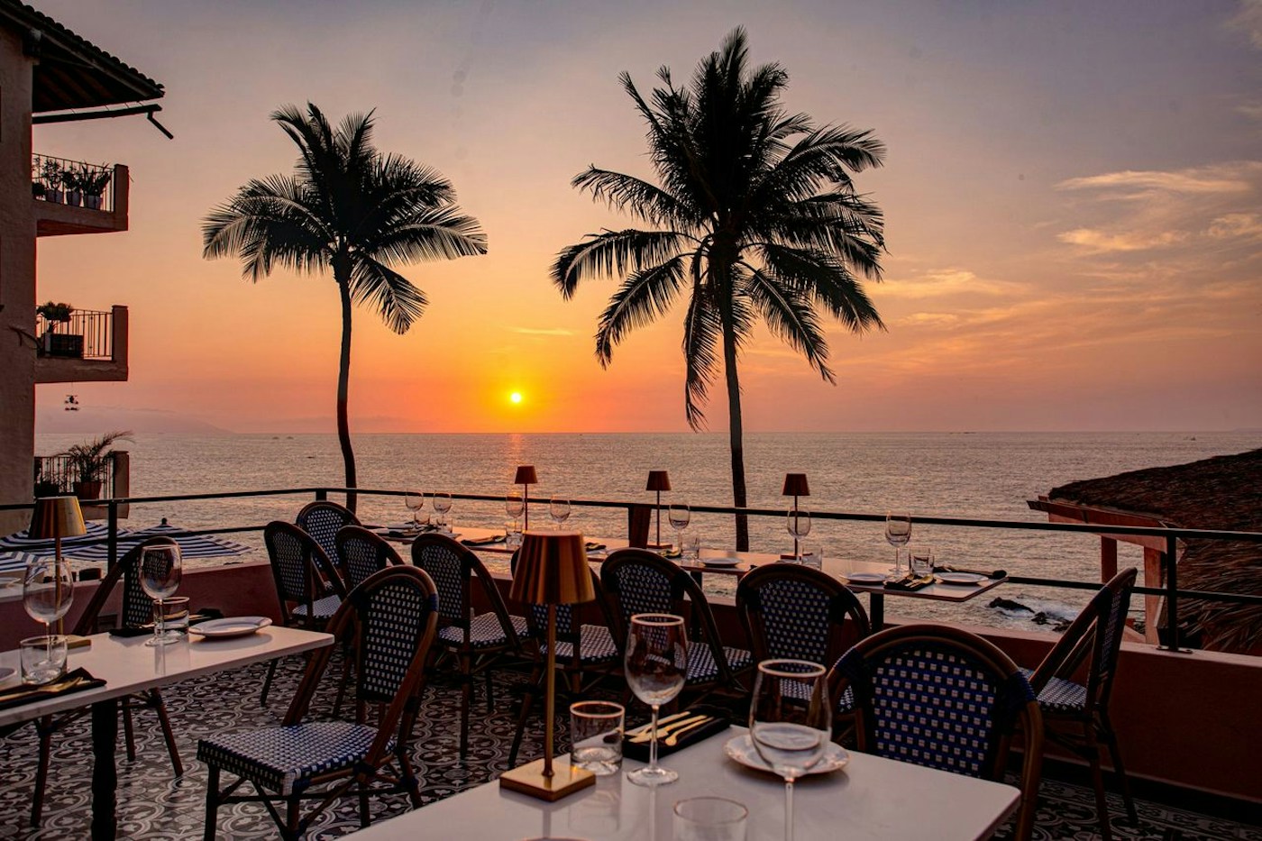 Tables set for sunset dining beside the Pacific at La Ola